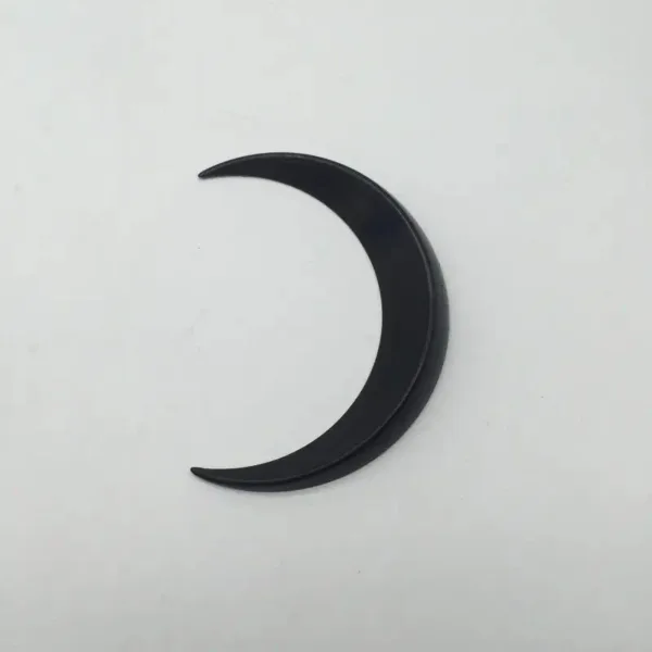 Black crescent moon shape cutout.