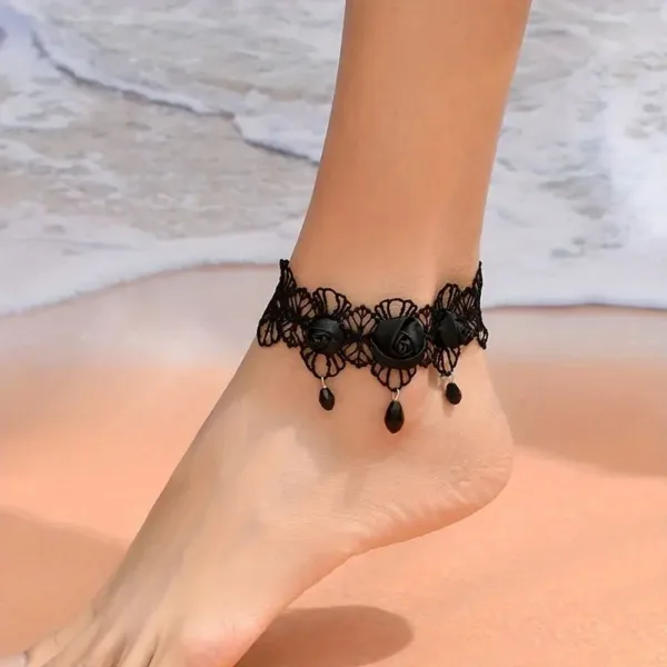 Black lace ankle bracelet with rose accents.