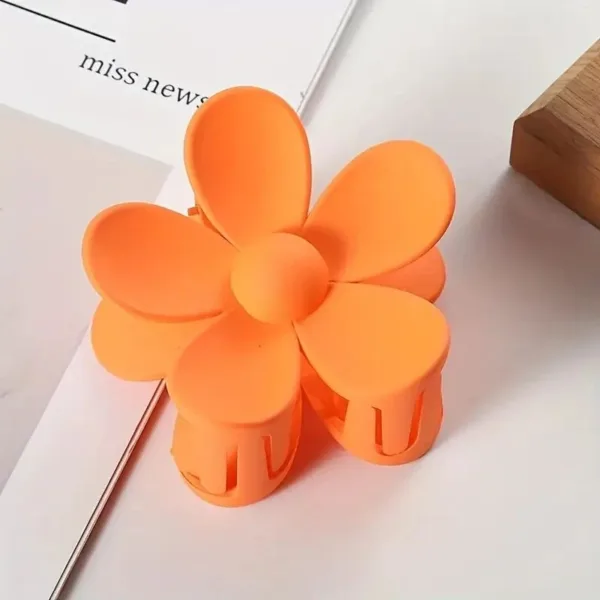 Orange flower shaped hair clip.