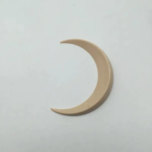 Beige crescent moon shaped ornament.