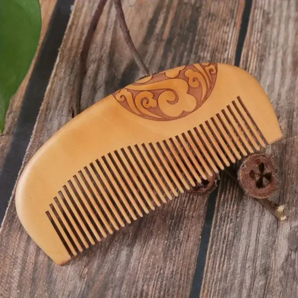 Wooden comb with intricate carving.