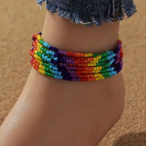 Rainbow beaded anklet on a woman's ankle.