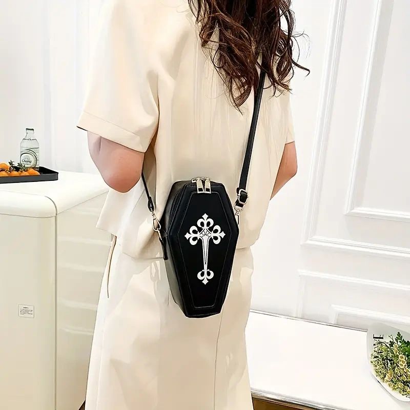 Black coffin-shaped crossbody bag with cross