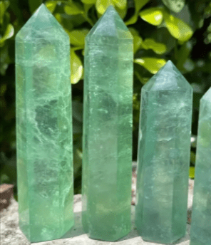 Four green fluorite crystal points.