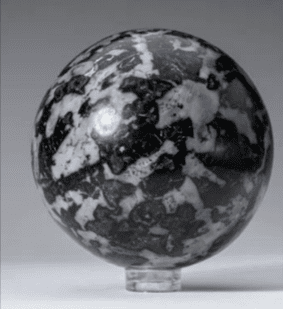 Black and white patterned sphere on stand.