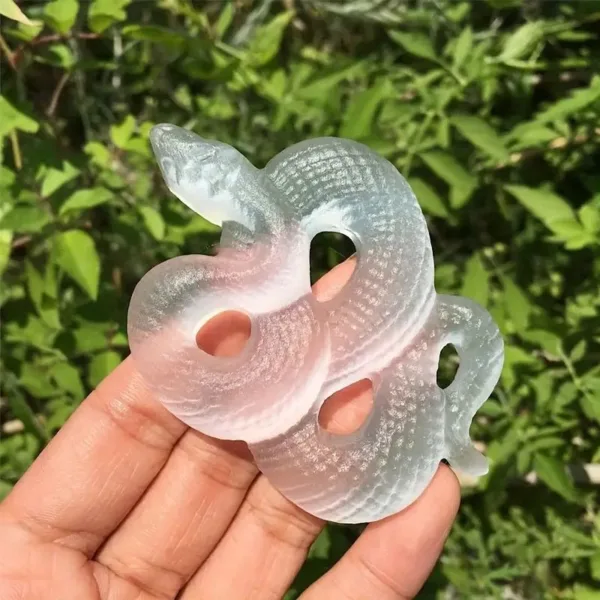 Glass snake sculpture in hand.