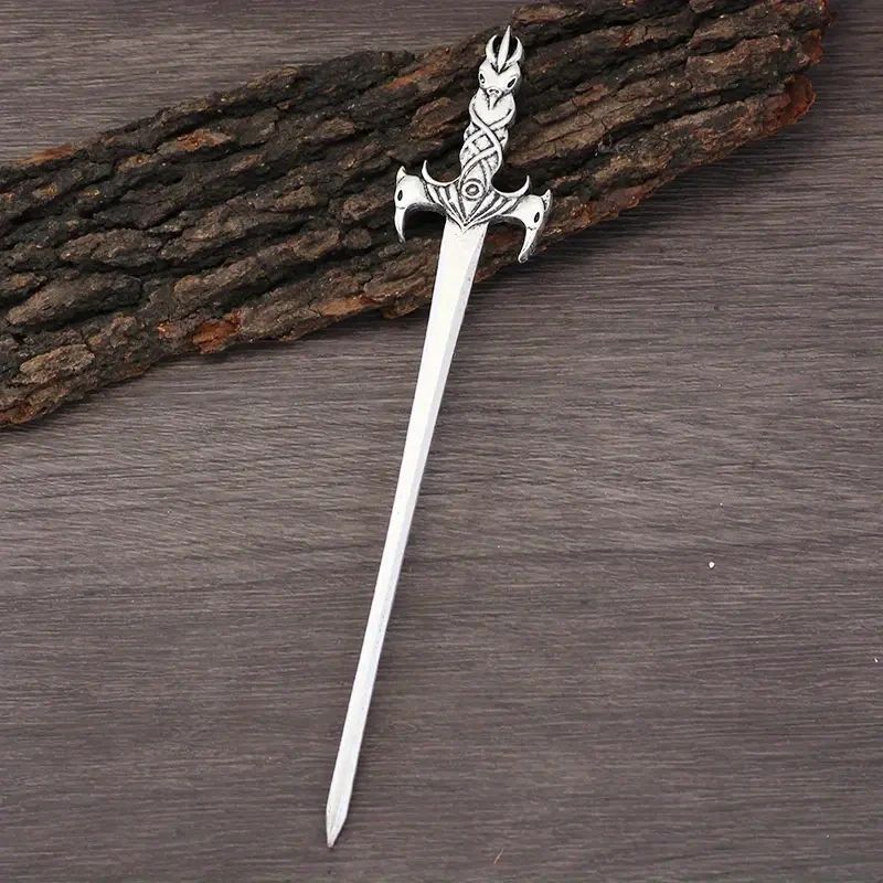 Ornate silver sword on wood background.