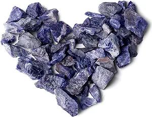 Heart-shaped arrangement of blue gemstone chips.