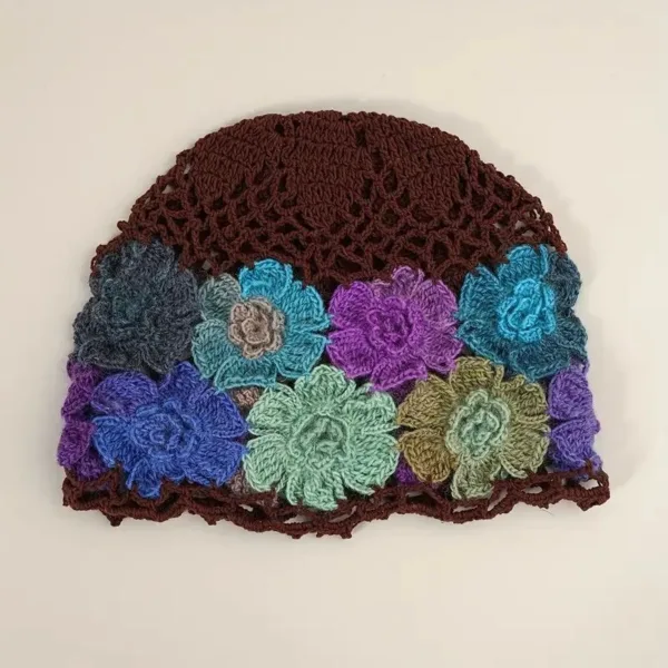 Crocheted brown hat with floral design.