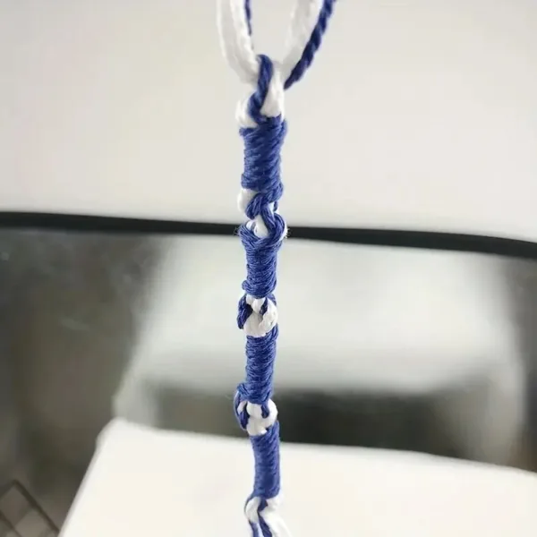 Blue and white knotted cord hanging.