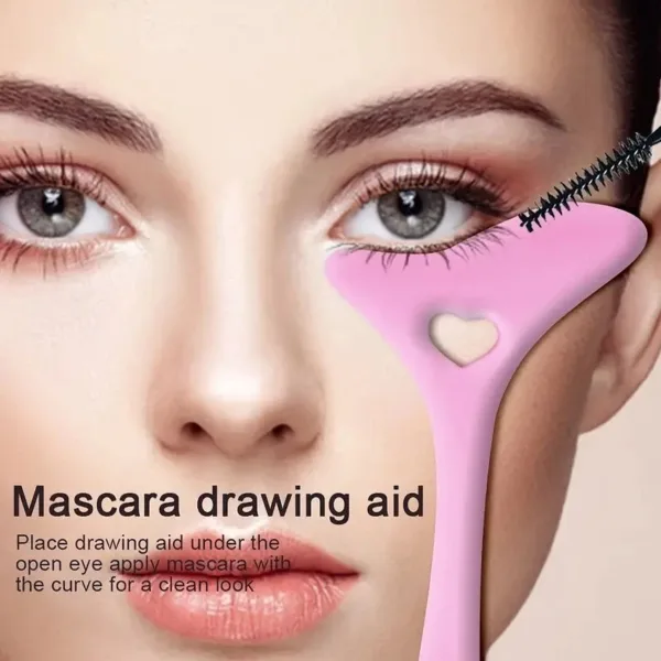 Pink mascara application tool near eye.