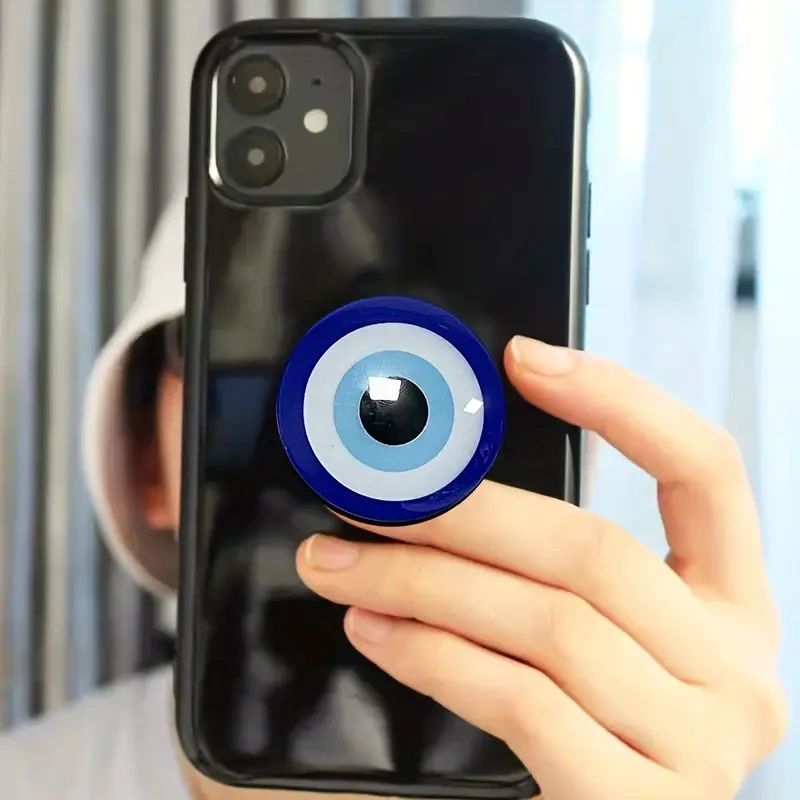 Black phone with evil eye pop socket.