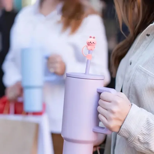 Purple tumbler with pink animal straw topper.