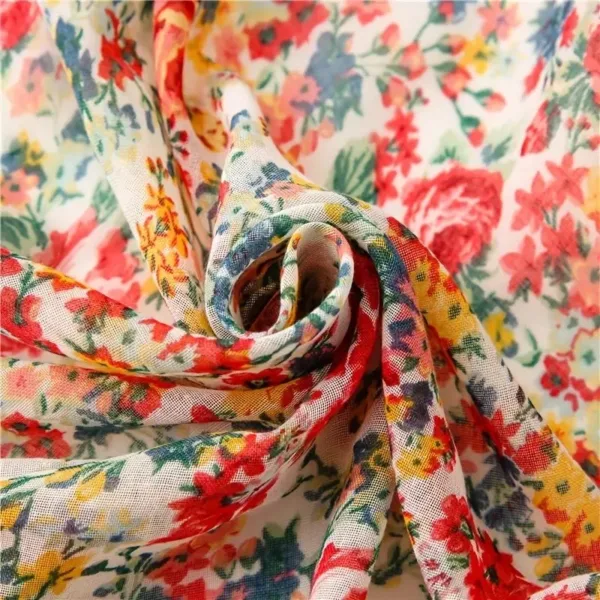 White fabric with red and yellow flowers.