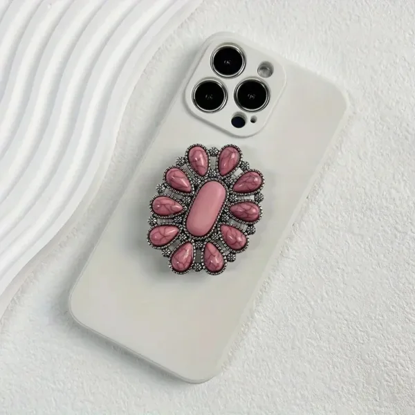 White phone case with pink gem ring holder.