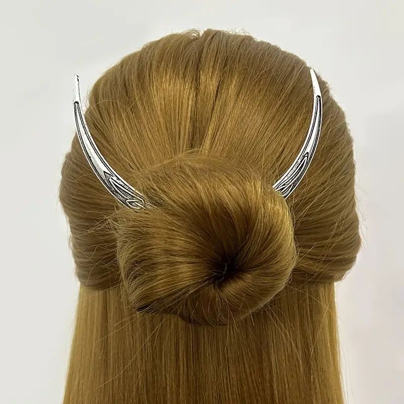 Woman with a bun and silver hair pin.