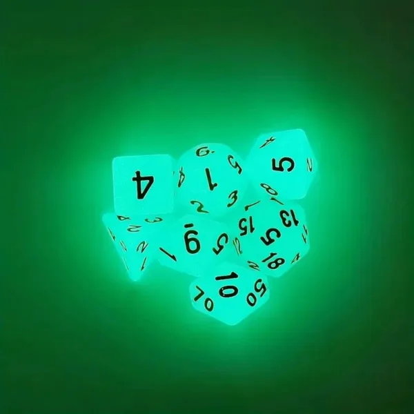 Glow-in-the-dark dice on green background.