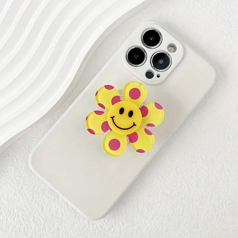 White phone case with a smiley flower.