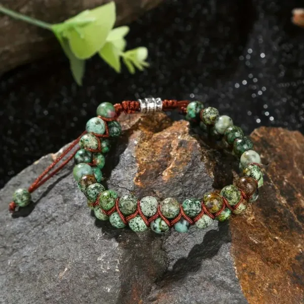 Green stone beaded bracelet on rock.