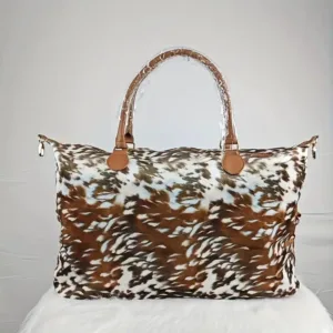 Brown and white animal print duffel bag.