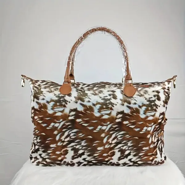 Brown and white animal print duffel bag.