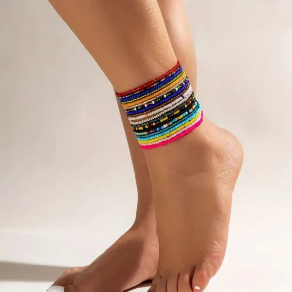 Colorful beaded ankle bracelet on a foot.