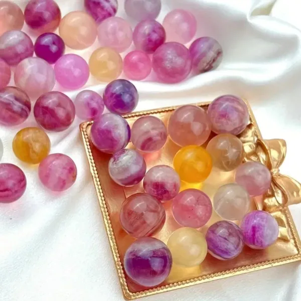 Pink and white crystal ball ornaments on tray.