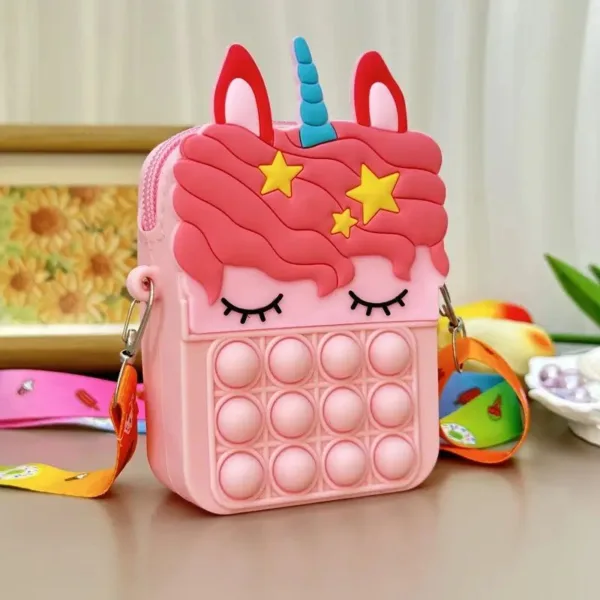 Pink unicorn pop it purse with strap.