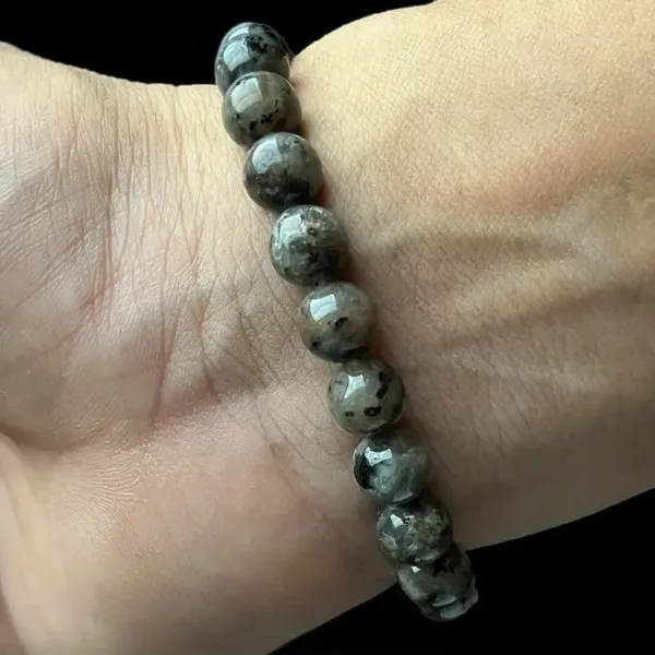 Black and gray beaded bracelet on wrist.