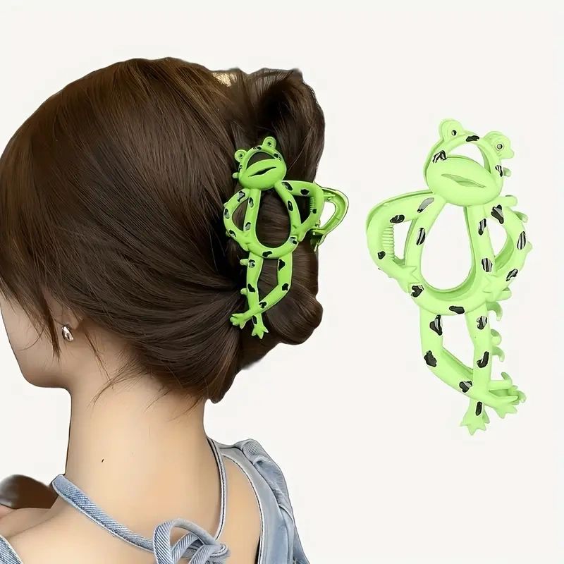 Green frog hair clip in woman's hair.