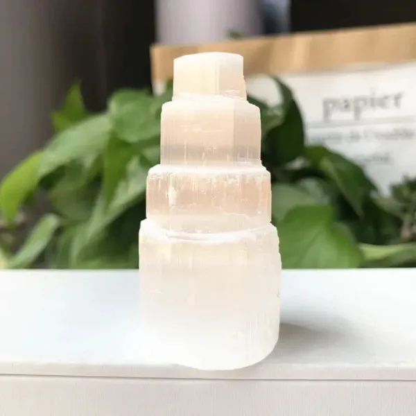 White selenite crystal tower on a table.