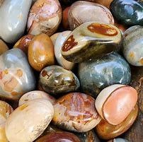 Smooth, colorful, polished stones in a pile.