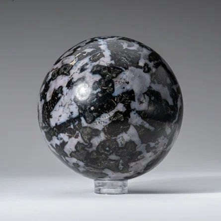 Black and white marble sphere on stand.