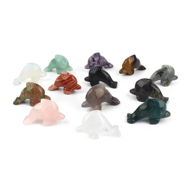 Collection of carved gemstone dolphin figurines.