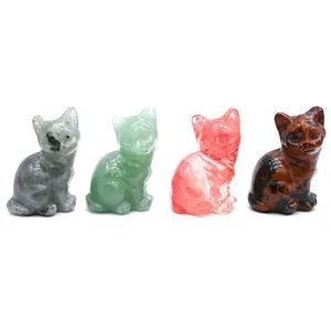 Four small carved crystal cat figurines.