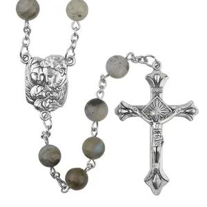 Silver rosary with angel and crucifix.