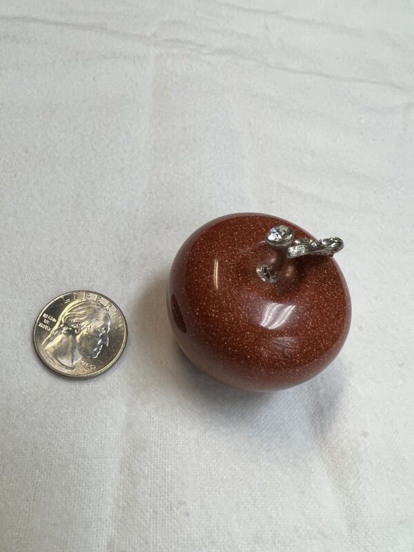 Red stone apple with silver stem.