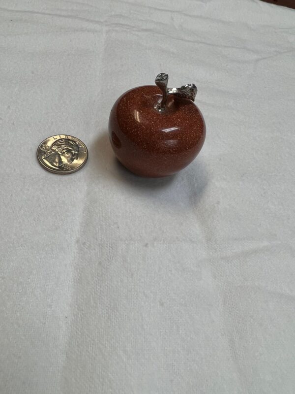 Red stone apple with silver stem.