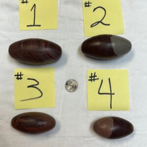 Four numbered striped stones on white background.