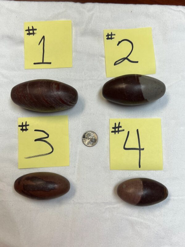 Four numbered striped stones on white background.