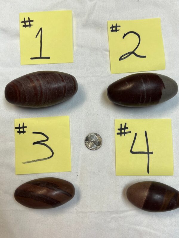 Four brown striped stones with numbers.