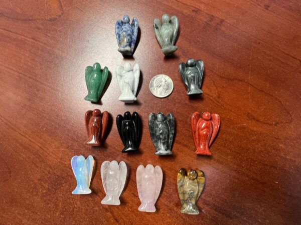 Collection of carved gemstone angel figurines.