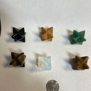 Six gemstone merkabah crystals on white.