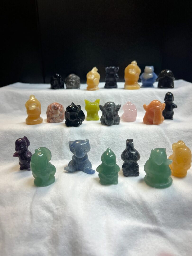 Collection of colorful carved gemstone figures.