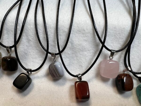 Assortment of gemstone necklaces on cord.