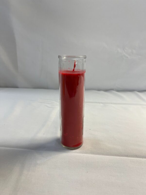 Red glass candle on white background.