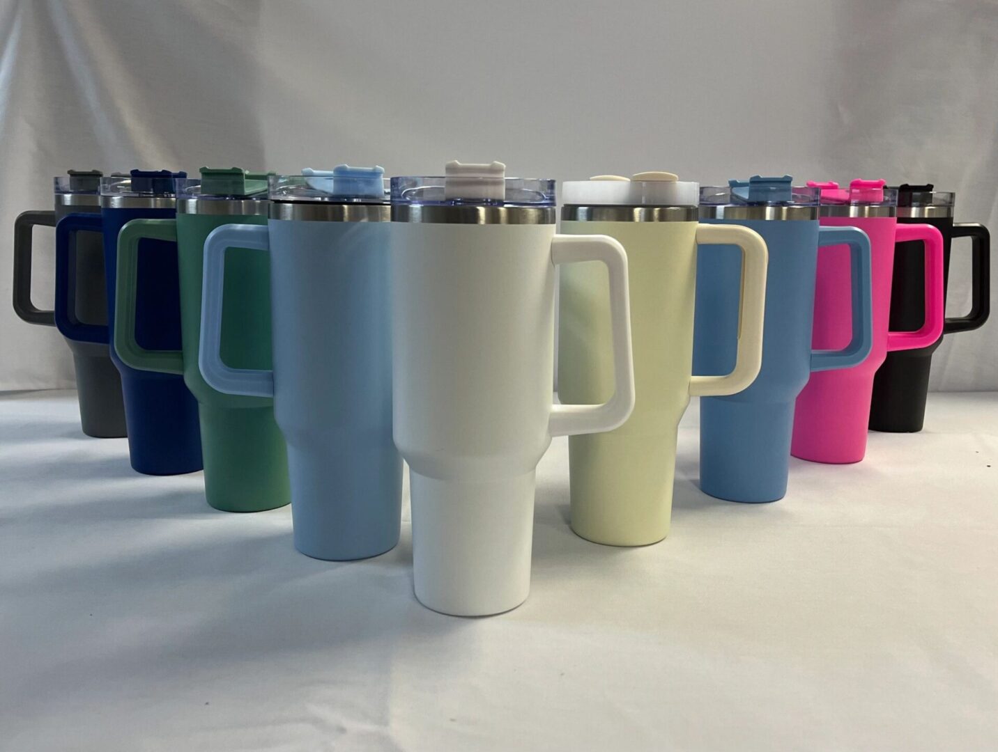 Colorful travel mugs with handles.