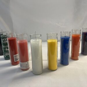 Seven colorful glass candles on a white surface.