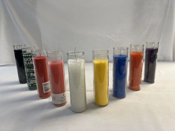 Seven colorful glass candles on a white surface.