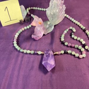 Green fluorite crystal necklace with amethyst pendant.